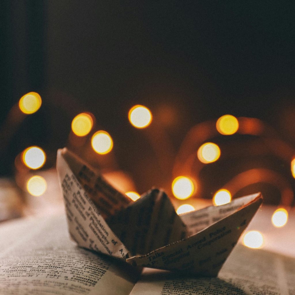 Paper boat on black background